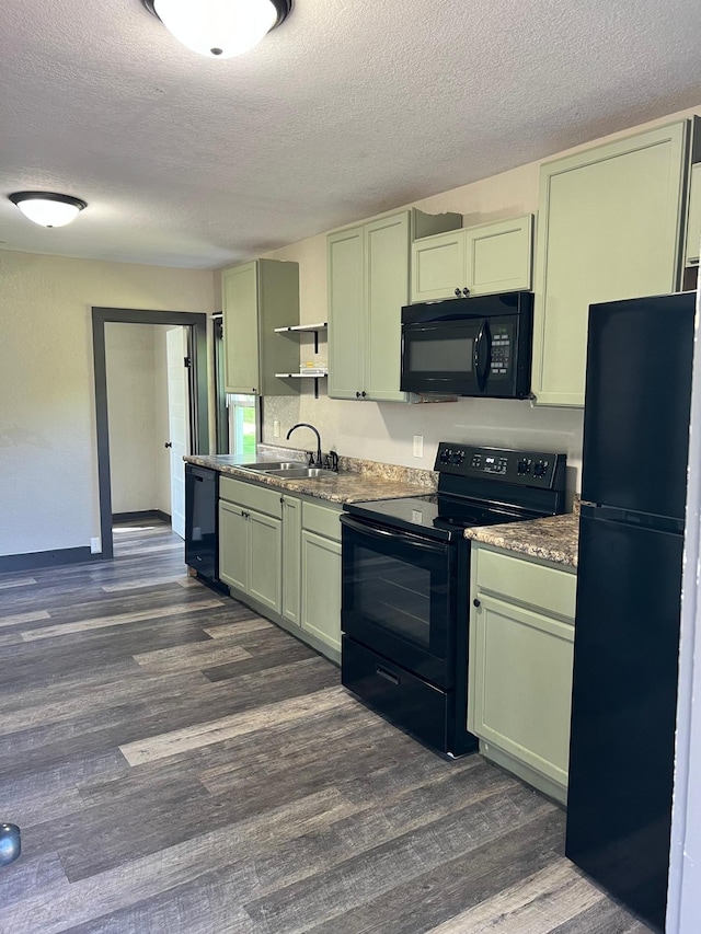 kitchen featuring a textured ceiling, sink, black appliances, and dark hardwood / wood-style floors