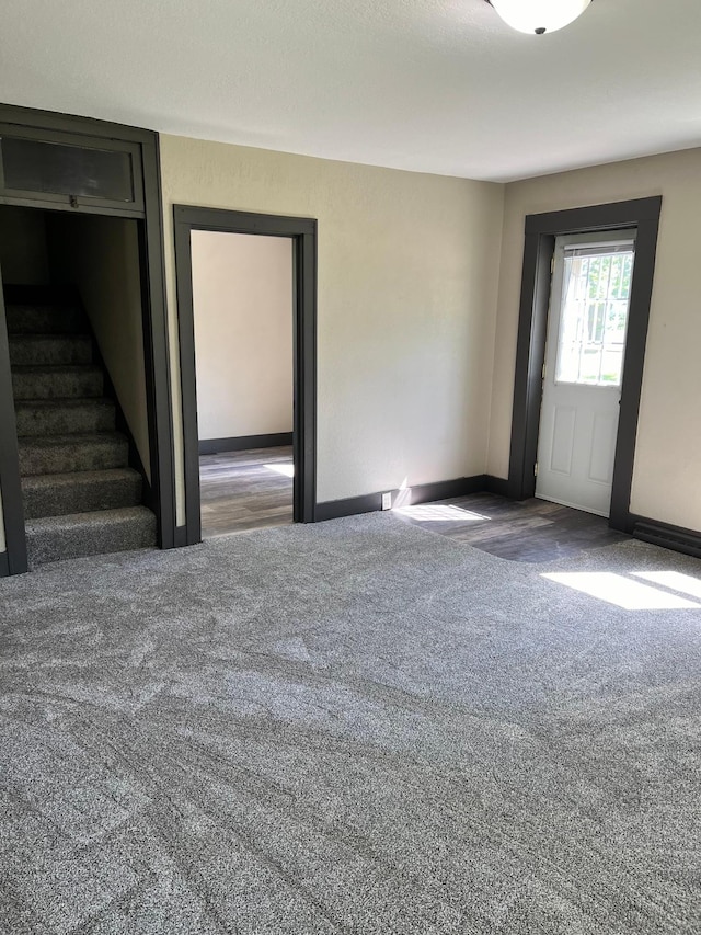 empty room with dark colored carpet