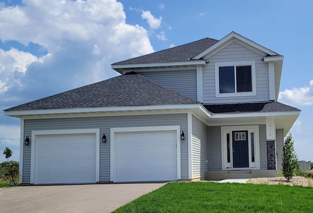 view of property featuring a garage and a front yard