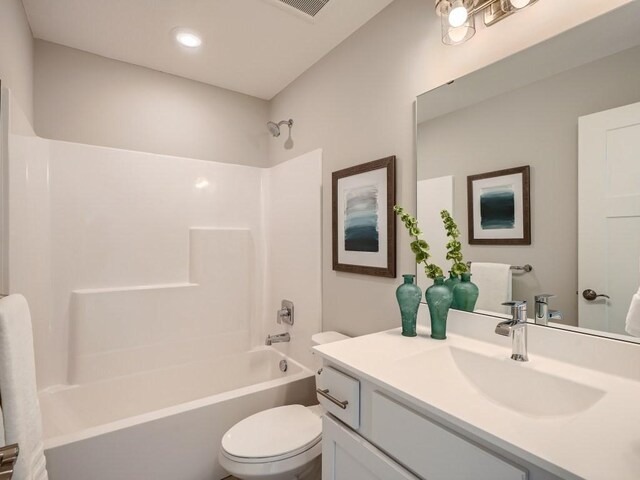 full bathroom with shower / tub combination, vanity, and toilet