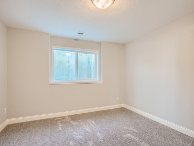 unfurnished room with carpet flooring