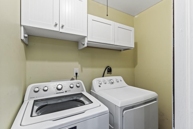 laundry room with washer and clothes dryer and cabinets