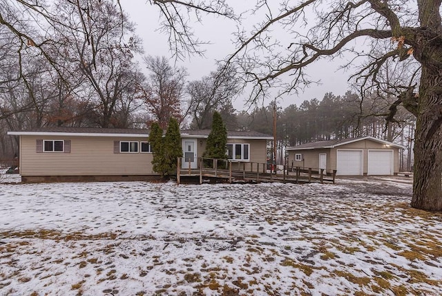 view of front of property with an outbuilding, a garage, and a deck