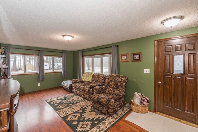 living room featuring plenty of natural light, hardwood / wood-style floors, and a textured ceiling