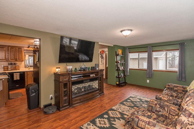 living room with wood-type flooring and a textured ceiling