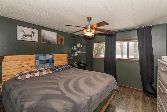 bedroom with ceiling fan and dark wood-type flooring