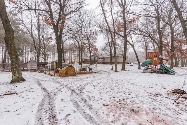 yard layered in snow with a playground