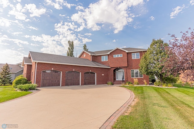 view of front facade featuring a front yard and a garage