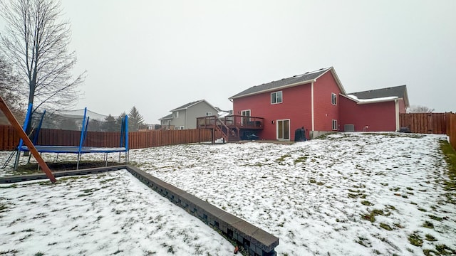 snowy yard with a trampoline