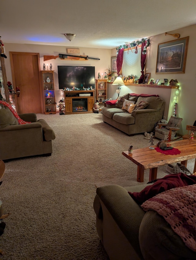 carpeted living area with a glass covered fireplace