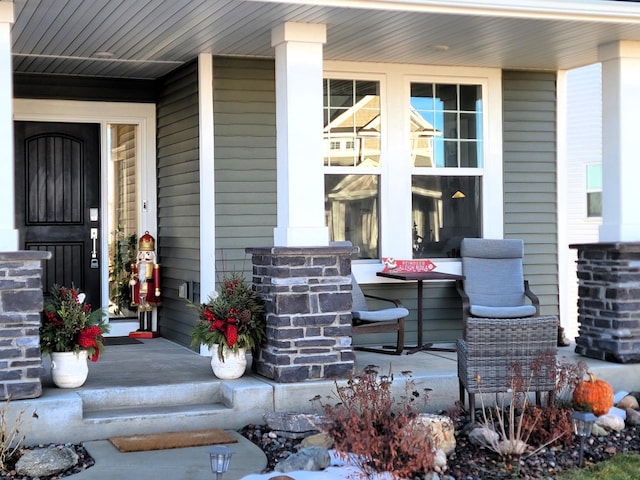 view of exterior entry with covered porch