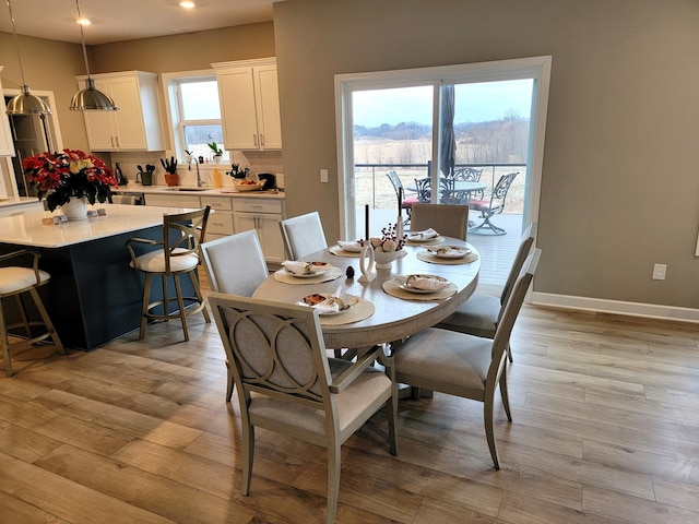 dining area featuring light hardwood / wood-style flooring and sink