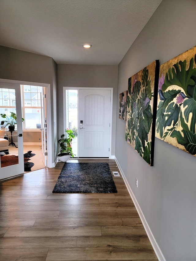 foyer featuring hardwood / wood-style flooring and french doors