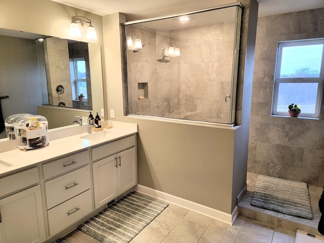 bathroom featuring tile patterned floors, vanity, and tiled shower