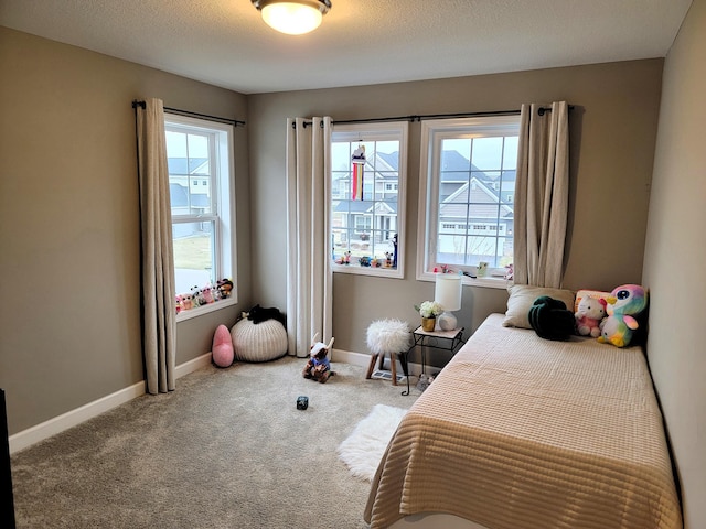 carpeted bedroom with a textured ceiling