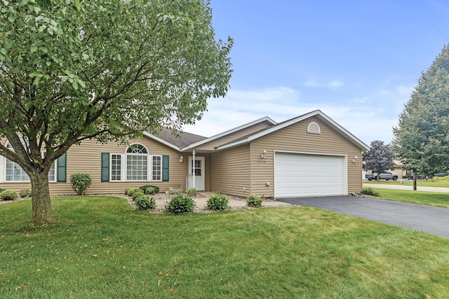 ranch-style house featuring a garage and a front lawn