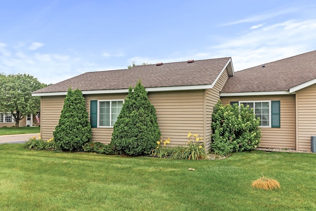 view of side of home featuring a lawn