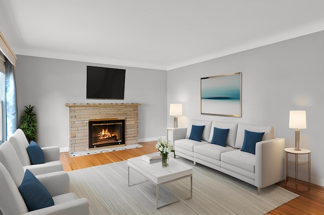 living room with light wood-type flooring and a stone fireplace