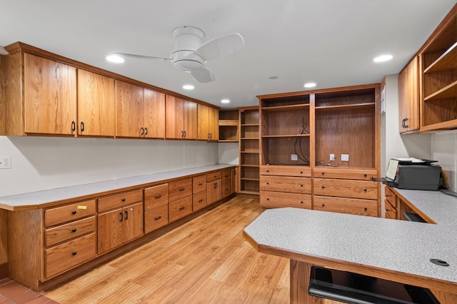 kitchen with ceiling fan, light hardwood / wood-style floors, and kitchen peninsula