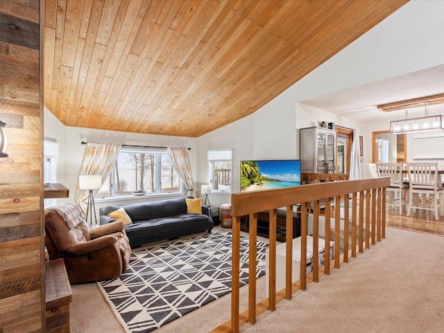 living room with carpet, wooden ceiling, and vaulted ceiling