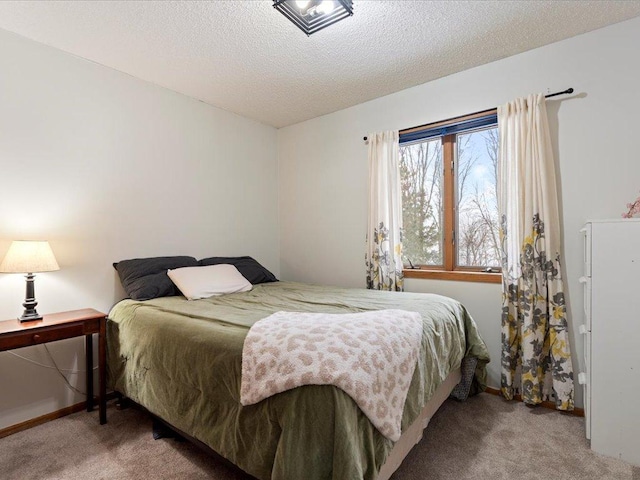 bedroom featuring carpet and a textured ceiling