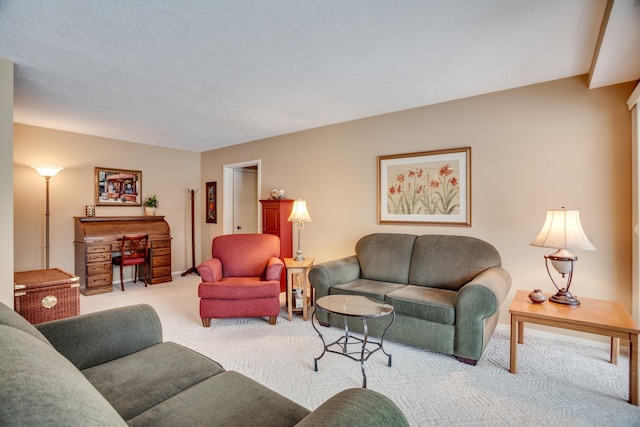 carpeted living room featuring a textured ceiling