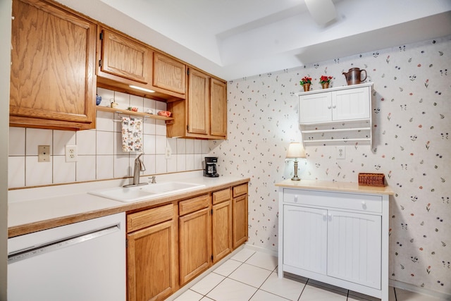 kitchen with sink, light tile patterned floors, white dishwasher, and decorative backsplash