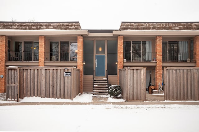 view of snow covered property entrance