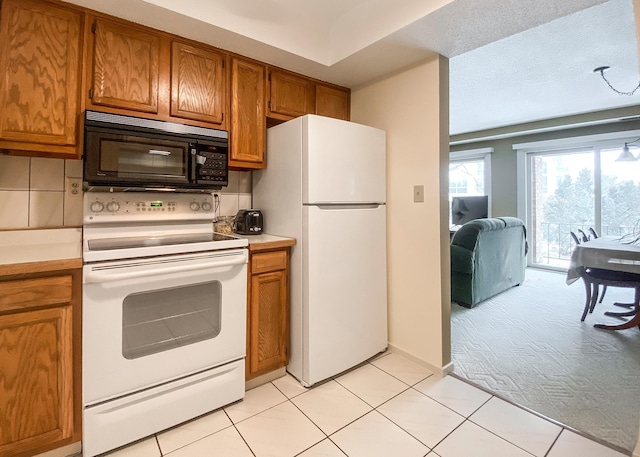 kitchen featuring light carpet, white appliances, and decorative backsplash