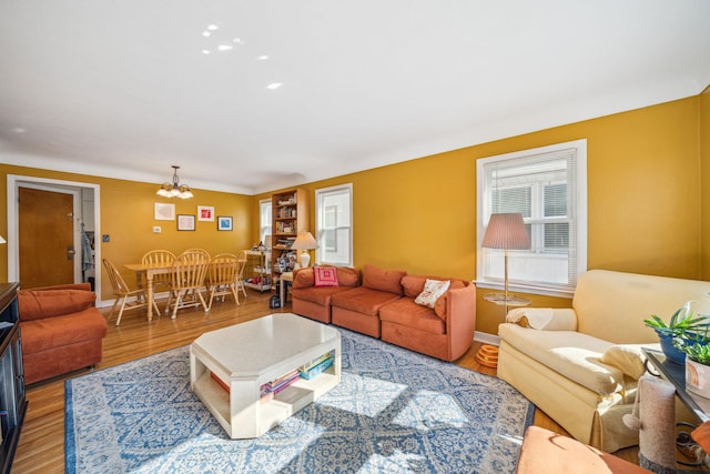 living room featuring hardwood / wood-style floors and an inviting chandelier