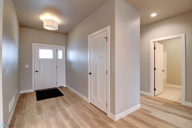 foyer entrance with light wood-type flooring