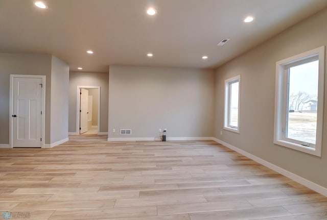empty room with light hardwood / wood-style flooring
