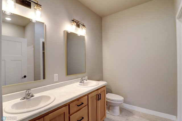 bathroom with tile patterned flooring, vanity, and toilet