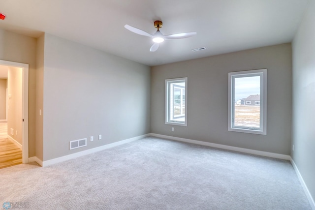 carpeted empty room with ceiling fan