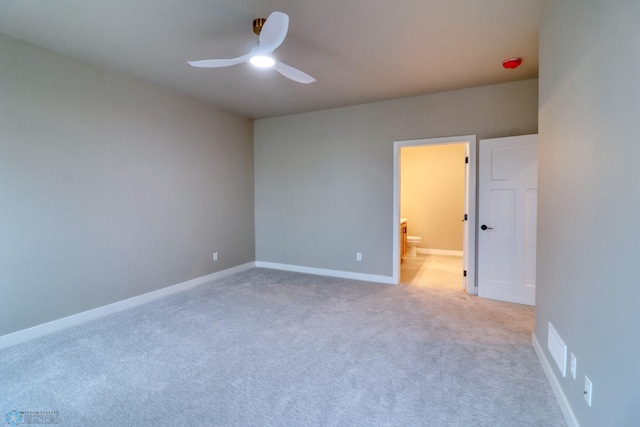 spare room with light carpet and ceiling fan