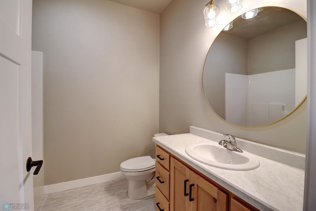 bathroom with vanity, toilet, and walk in shower