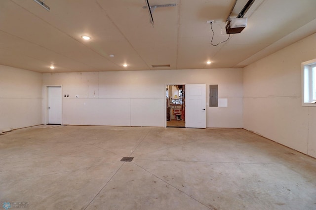 garage with a garage door opener and electric panel