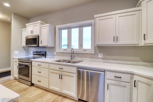 kitchen with white cabinets, sink, and stainless steel appliances