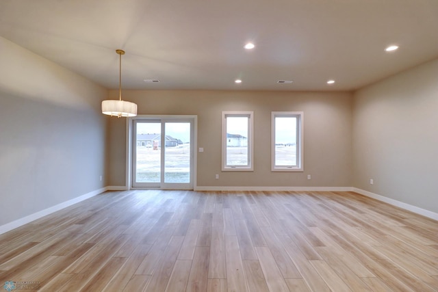 spare room featuring light hardwood / wood-style floors