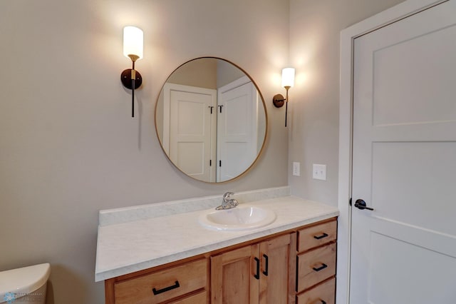 bathroom with vanity and toilet