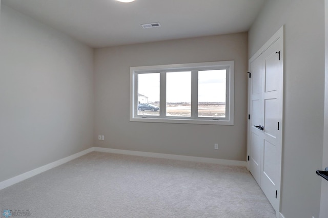 empty room featuring light carpet