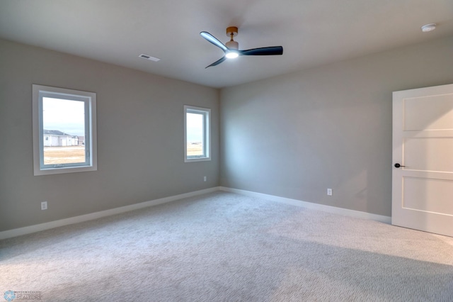 carpeted spare room with ceiling fan