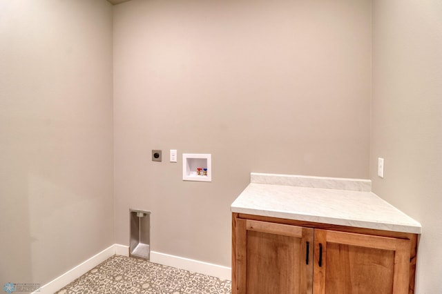 laundry area with hookup for an electric dryer, washer hookup, and cabinets