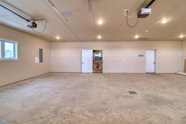 garage featuring electric panel and a garage door opener