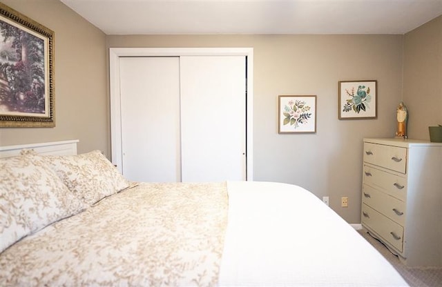 carpeted bedroom with a closet