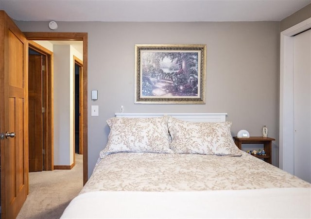 bedroom featuring light colored carpet and a closet