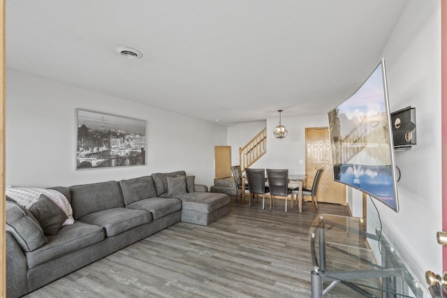 living room featuring hardwood / wood-style flooring and a chandelier