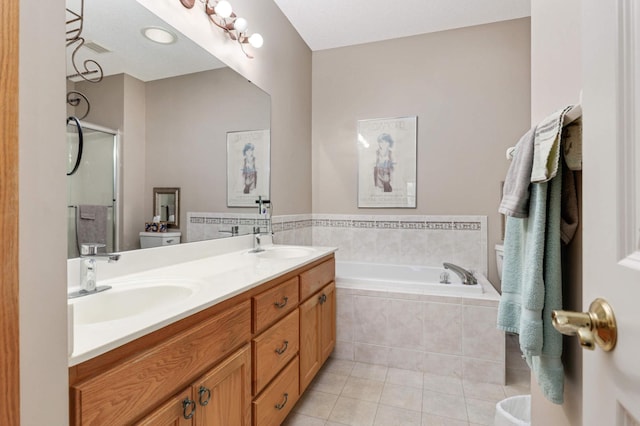 bathroom featuring tile patterned floors, independent shower and bath, and vanity