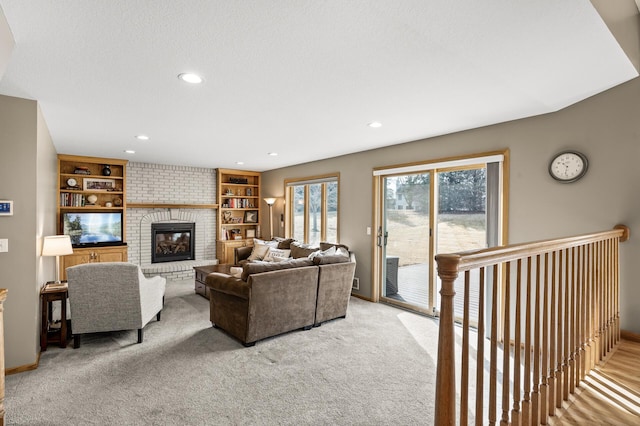 living area featuring a brick fireplace, baseboards, carpet floors, recessed lighting, and a textured ceiling