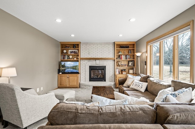 living room with recessed lighting, a fireplace, and carpet floors